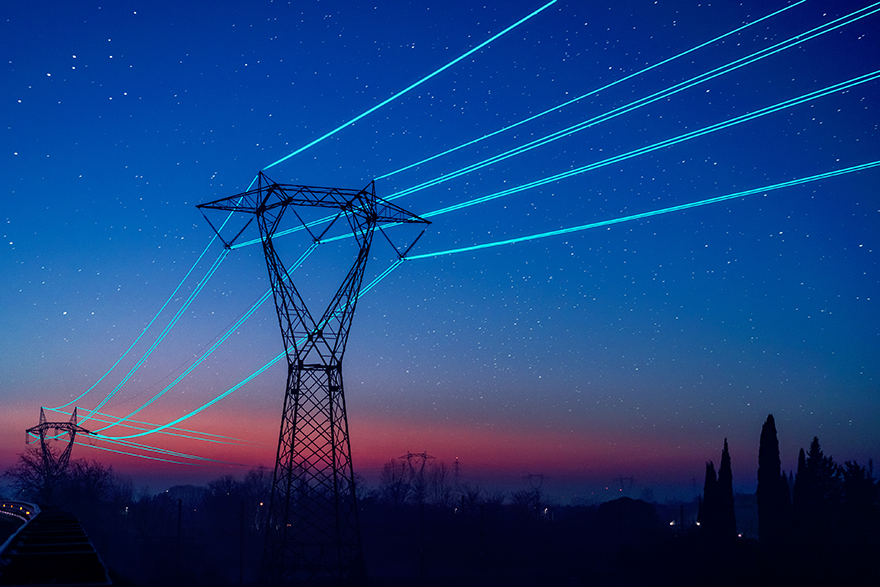Towers with power lines at night